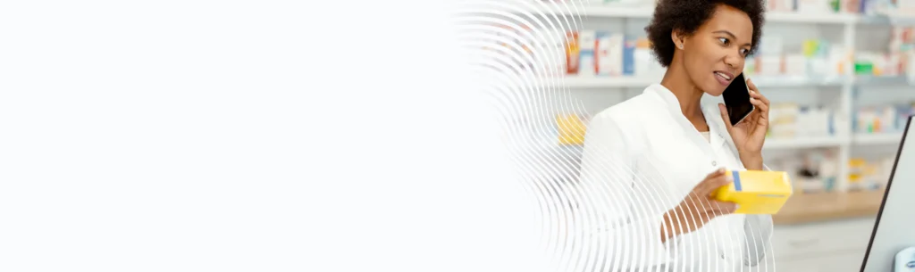 Pharmacist with a mobile device filling a package